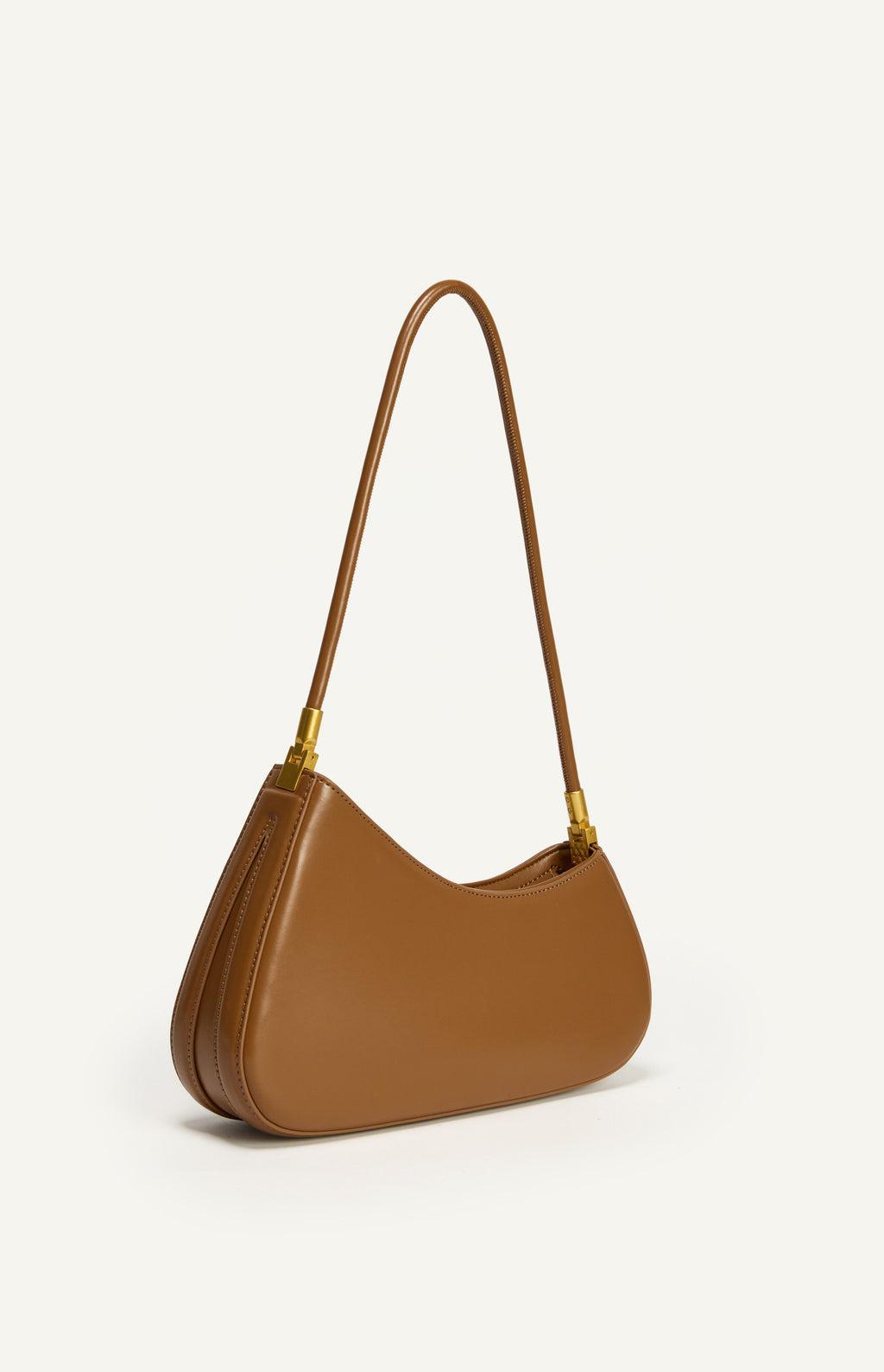 Shweetcheeks asymmetrical curved shoulder bag in smooth Caramel vegan leather with gold hardware detailing