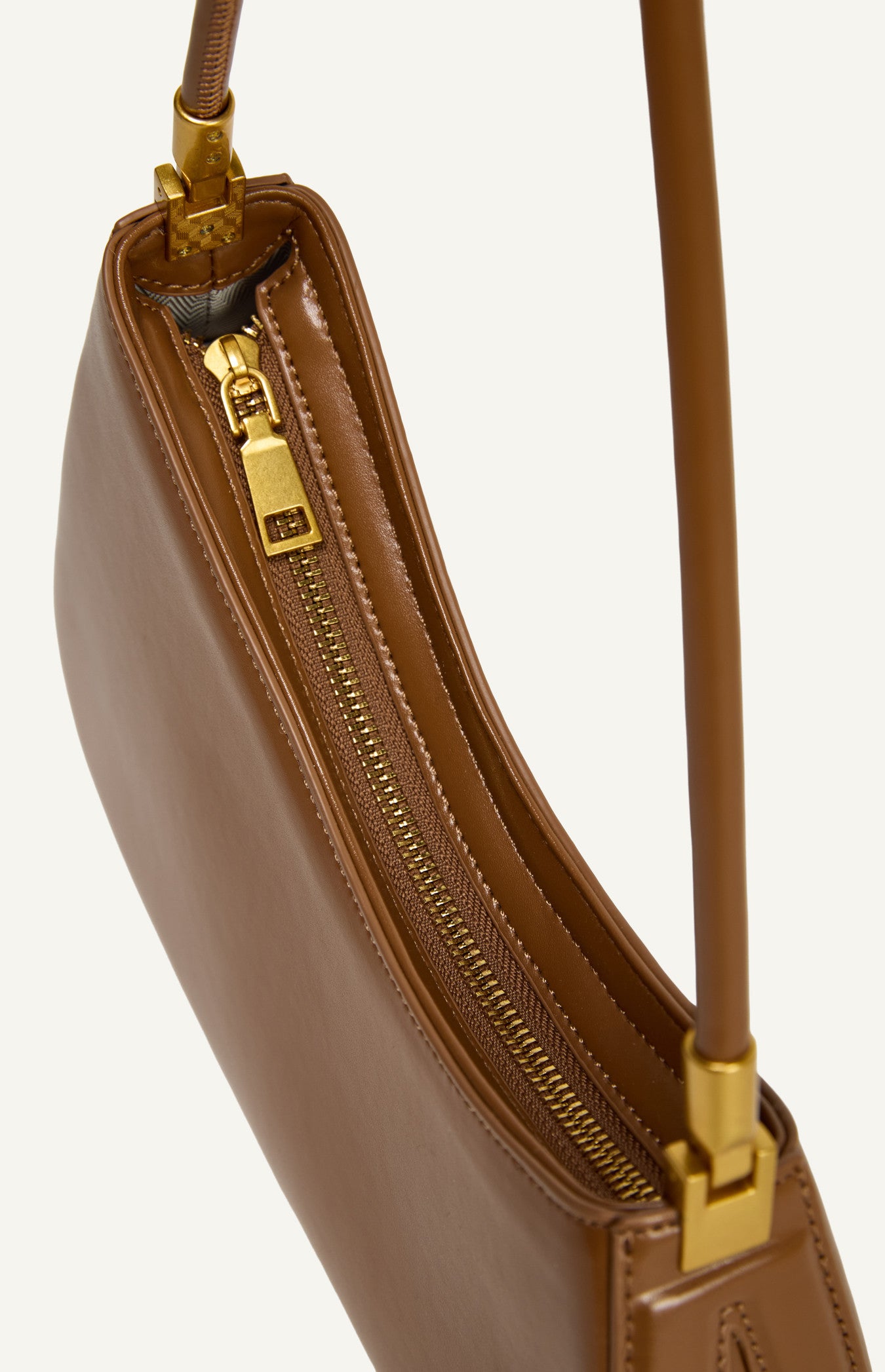 Premium gold hardware and secure zip-top closure on a smooth-finish vegan leather bag
