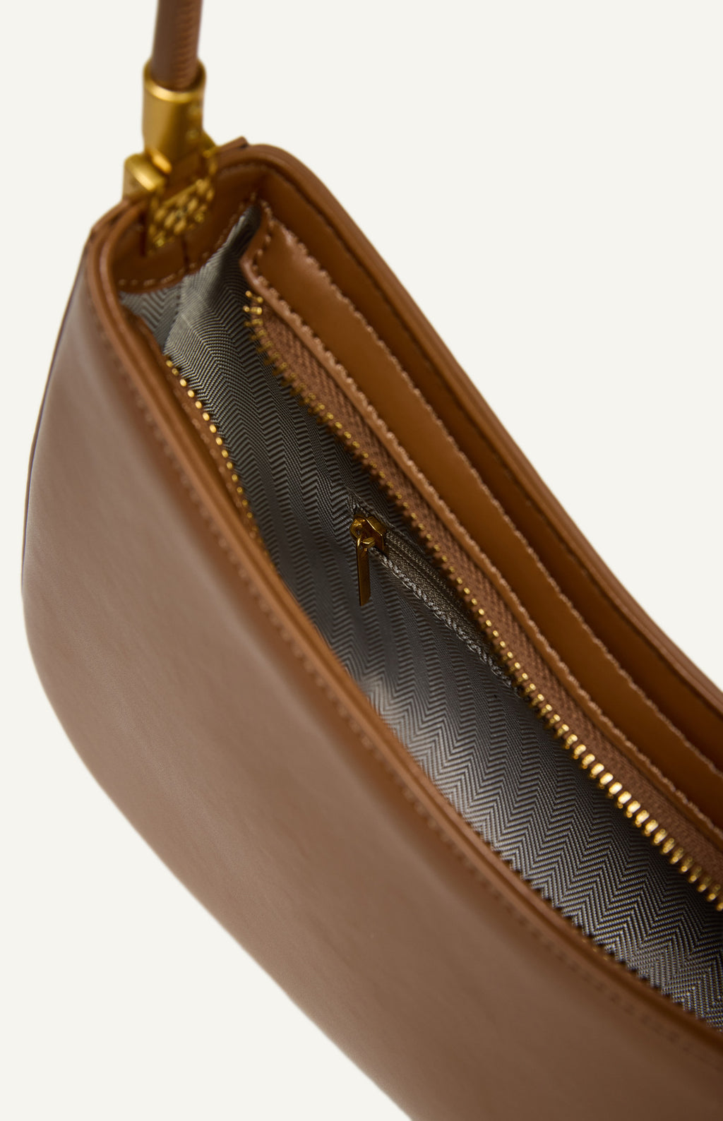 "Inside view of a vegan leather purse showing the synthetic fabric lining, internal pocket, and zip compartment