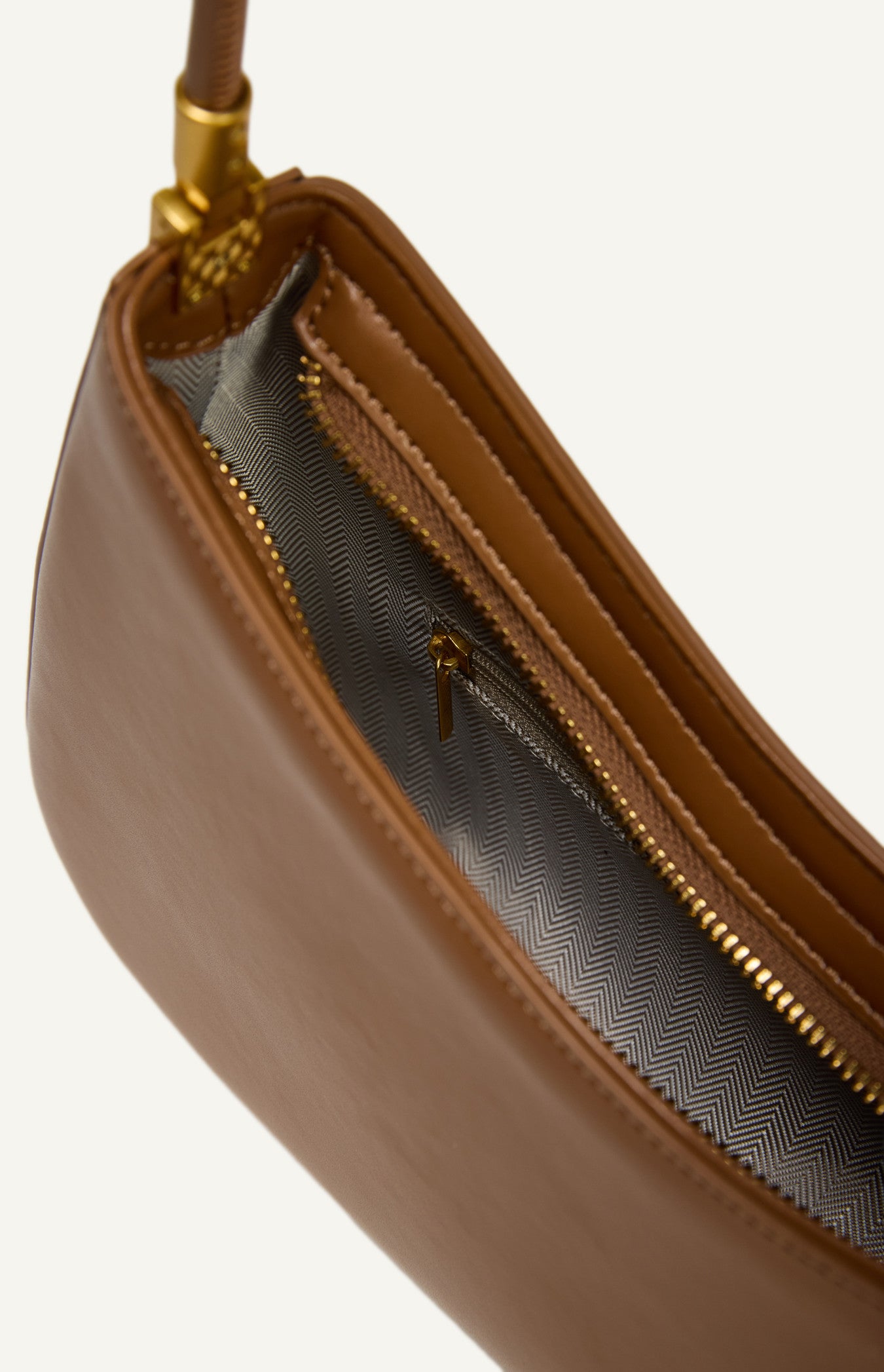 "Inside view of a vegan leather purse showing the synthetic fabric lining, internal pocket, and zip compartment