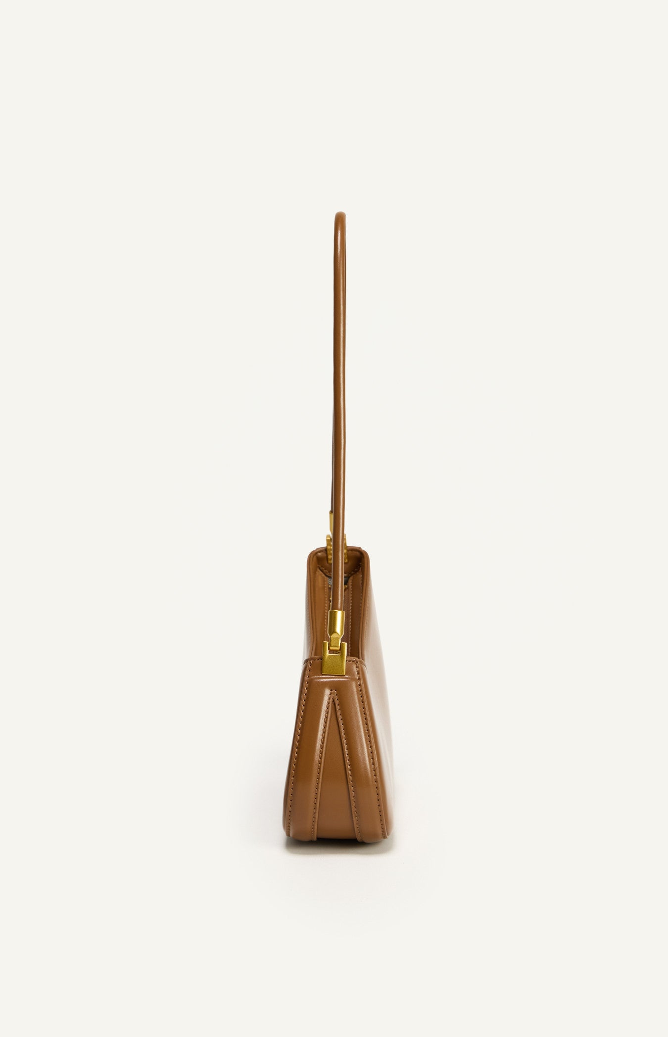 Caramel handbag with a gold handle on a white background